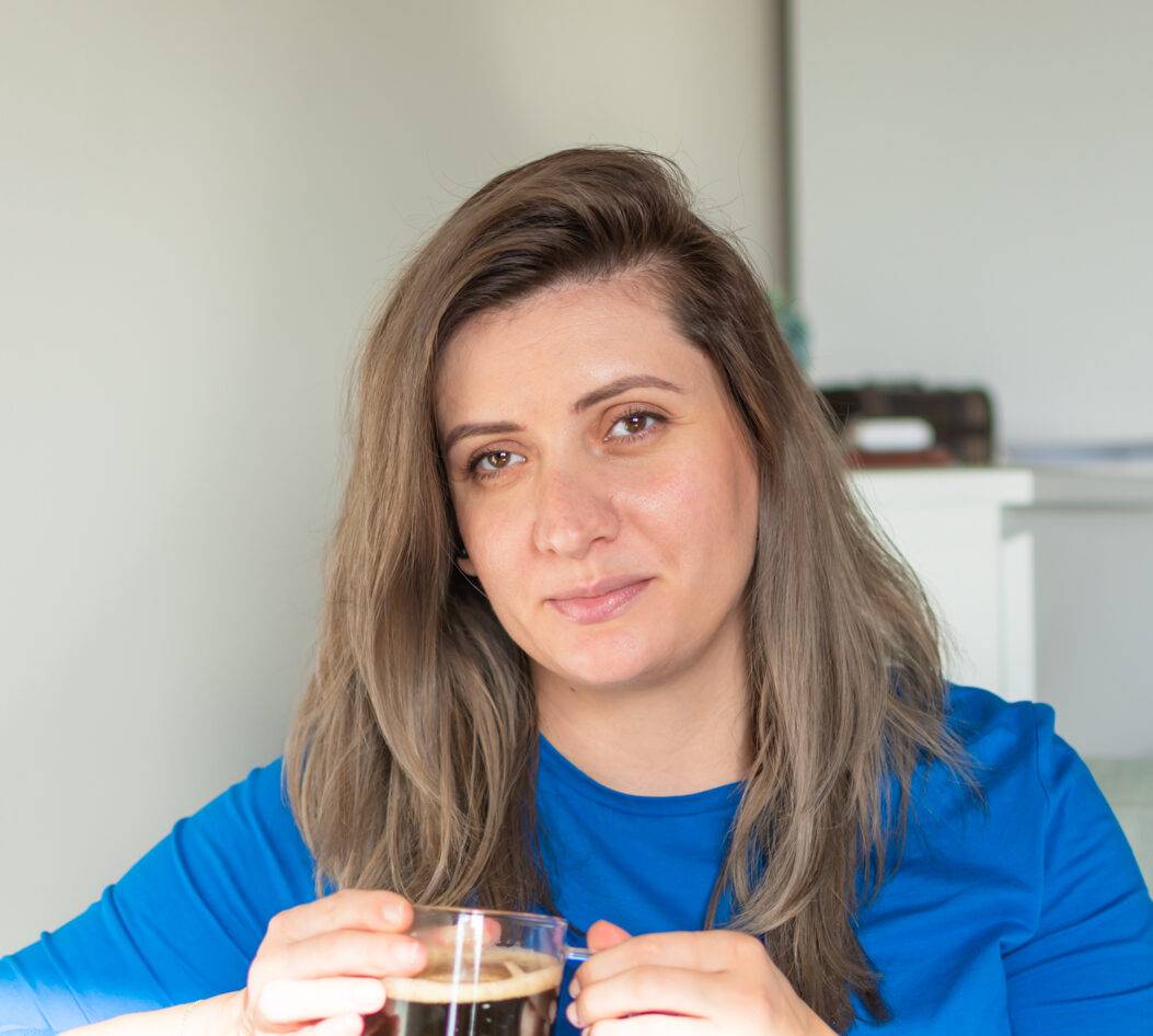 Denise Iordache holding a cup of coffee JoySpace Sleep Hypnotherapy Therapy